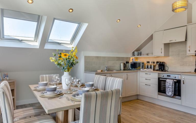 the kitchen and dining area in the Beachcomber apartment 