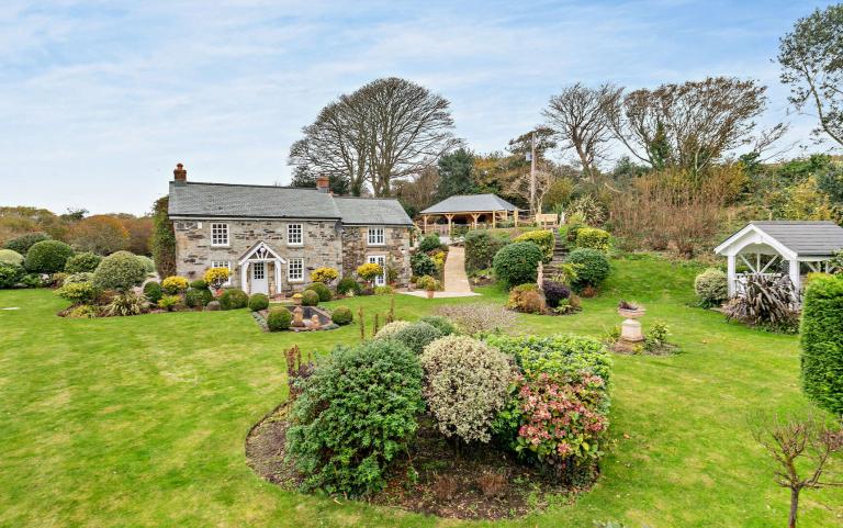 Outdoor View of Cottage in Beautiful Gardens