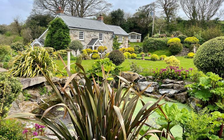 Outdoor View of Cottage in Beautiful Gardens