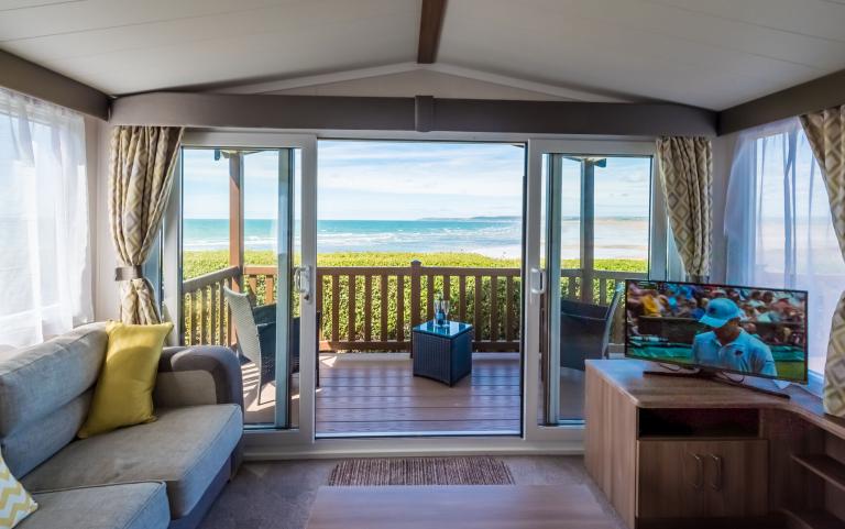 Living Area leading onto Outside Decking Area of a Caravan Holiday Home