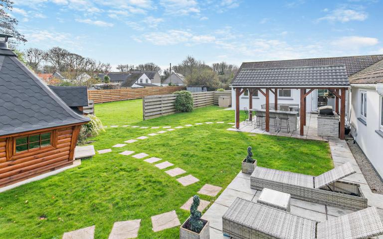 Outdoor View of Cottage in Beautiful Gardens 