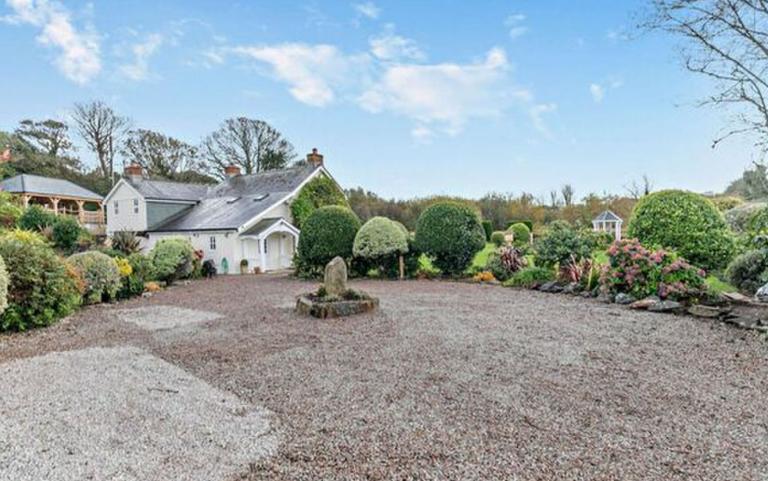 Outdoor View of Cottage in Beautiful Gardens