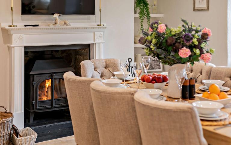 Dining Area in a Holiday Home Featuring a Log Burner