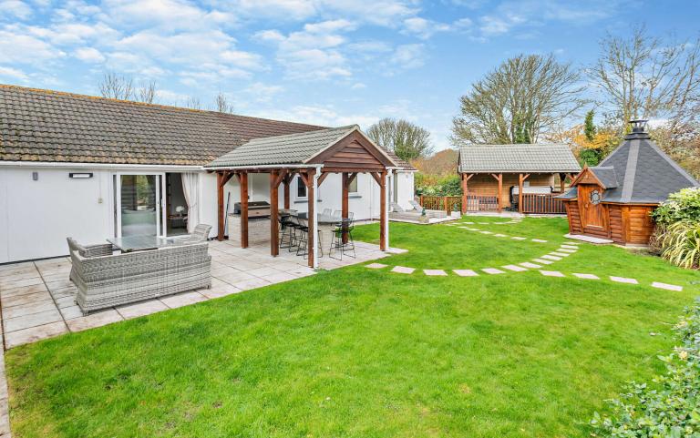 Outdoor View of Cottage in Beautiful Gardens 