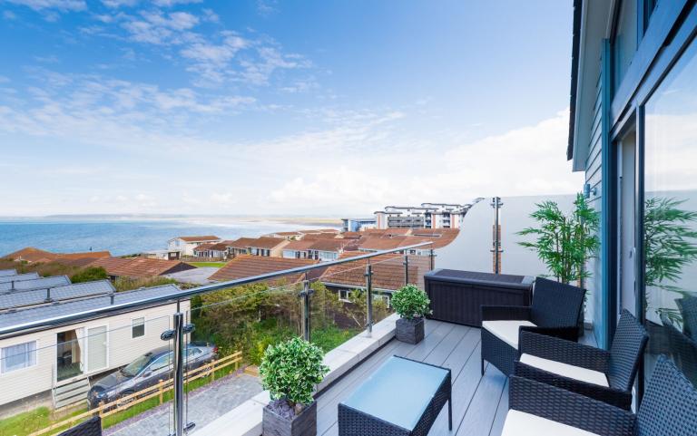 View from an Apartment Outside Decking Looking out over other Accommodation and the Sea