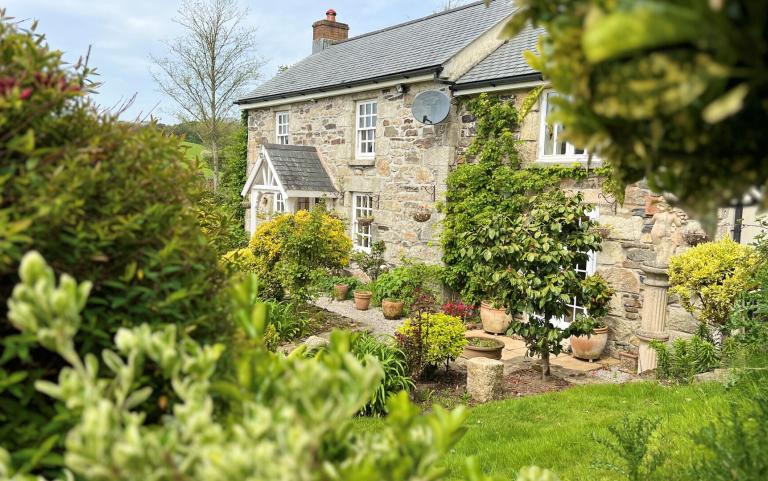 Outdoor View of Cottage in Beautiful Gardens