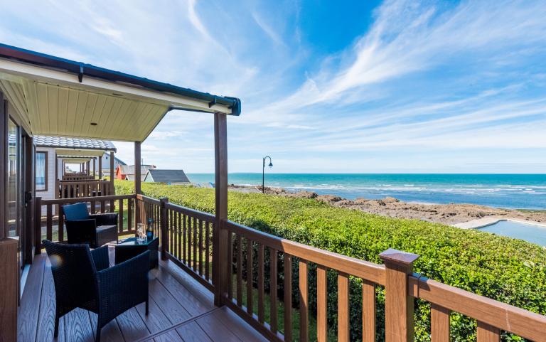 Outside Decking Area of a Caravan Holiday Home with Views over the Sea and Sea Pool