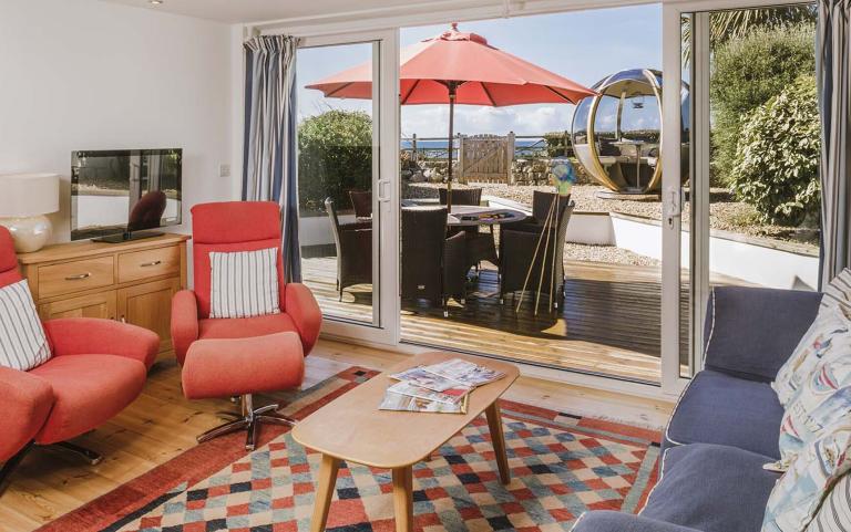 Outside View of a Holiday Home with a Decking area & Bespoke Outdoor Eating area, Taken from Living area