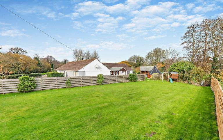 Outdoor View of Cottage in Beautiful Gardens 