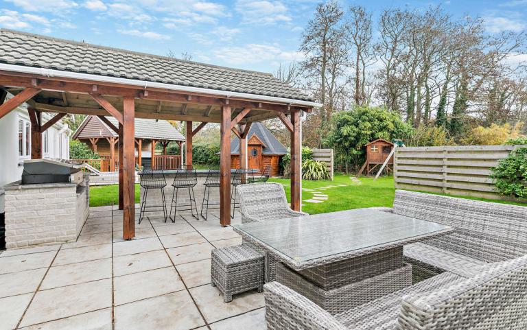 Outdoor View of a Cottages in Beautiful Gardens Featuring outdoor under cover BBQ area and Outdoor Seating