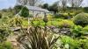 Outdoor View of Cottage in Beautiful Gardens