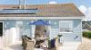 Outside View of a Holiday Home with a Decking area and Dining Table & Chairs