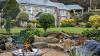 Outdoor View of Cottage in Beautiful Gardens Featuring outdoor Fireplace